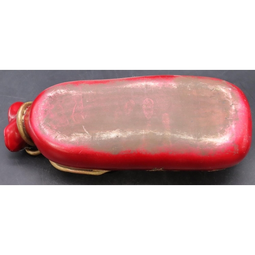 50 - An Oriental earthenware pillow in the form of a bag on red ground with gilt dragon decoration, 33cm ... 