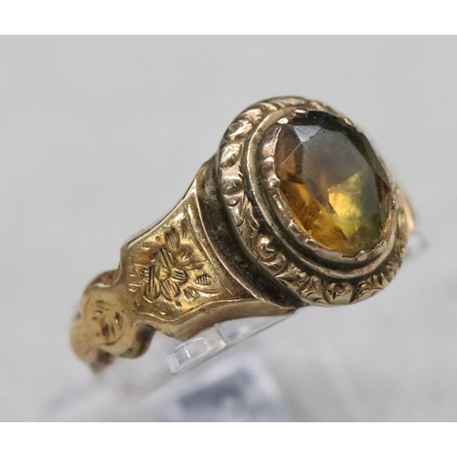 520 - A 19th Century gold ring set with Citrine style stone with allover chased floral and leaf decoration... 