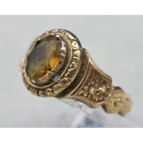 520 - A 19th Century gold ring set with Citrine style stone with allover chased floral and leaf decoration... 