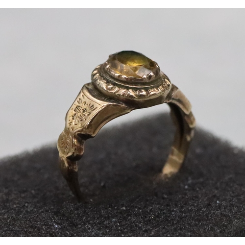 520 - A 19th Century gold ring set with Citrine style stone with allover chased floral and leaf decoration... 