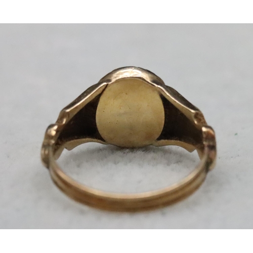 520 - A 19th Century gold ring set with Citrine style stone with allover chased floral and leaf decoration... 