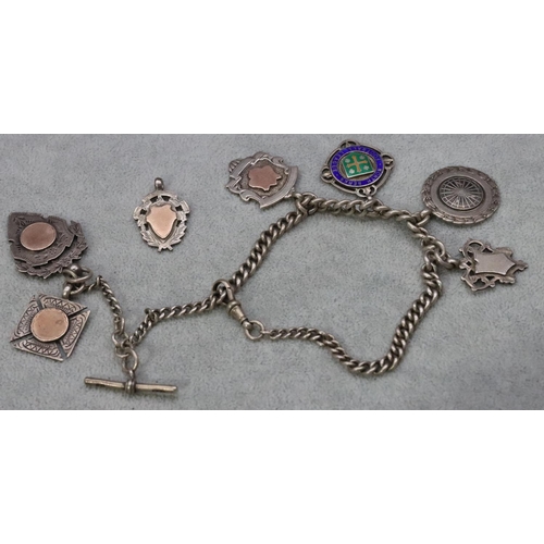 537 - A silver watch chain mounted with 7 silver badges, 81.8 grams gross