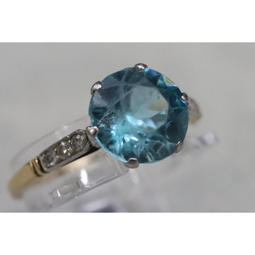 556 - A blue Zircon ladies' ring, flanked by 6 diamond chips to shoulders, (approx. 2.50ct), Size O, 2.5 g... 