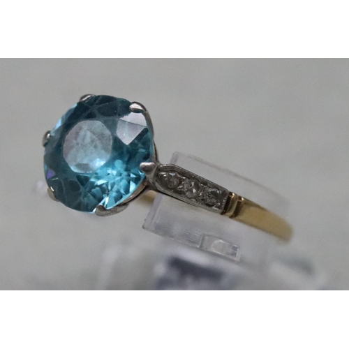 556 - A blue Zircon ladies' ring, flanked by 6 diamond chips to shoulders, (approx. 2.50ct), Size O, 2.5 g... 