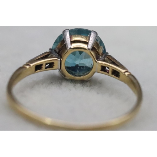 556 - A blue Zircon ladies' ring, flanked by 6 diamond chips to shoulders, (approx. 2.50ct), Size O, 2.5 g... 