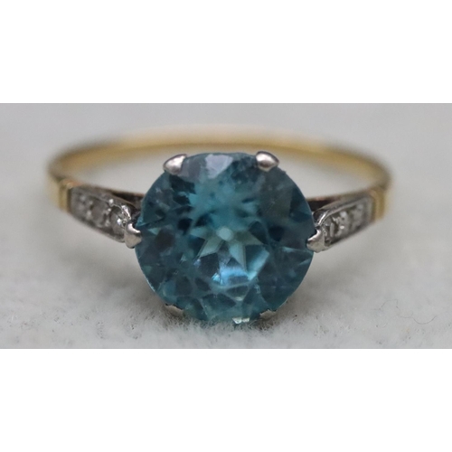 556 - A blue Zircon ladies' ring, flanked by 6 diamond chips to shoulders, (approx. 2.50ct), Size O, 2.5 g... 