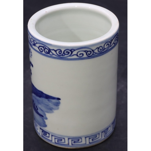 56 - An Oriental cylindrical brush pot on blue and white ground with figure and landscape decoration, 12.... 