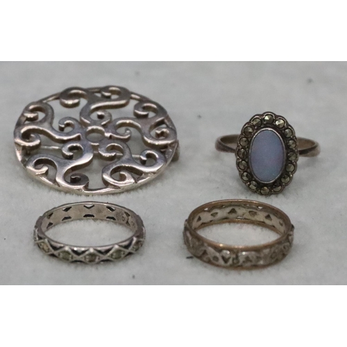 573 - A 925 silver circular brooch with pierced scroll decoration and 3 various silver rings, 16.5 grams g... 