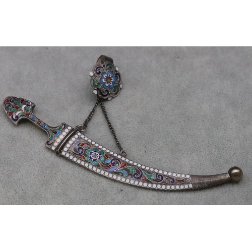 577 - A Continental silver miniature dagger with allover multi-coloured enamelled decoration, with chain a... 