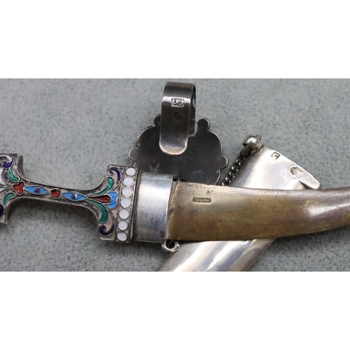 577 - A Continental silver miniature dagger with allover multi-coloured enamelled decoration, with chain a... 