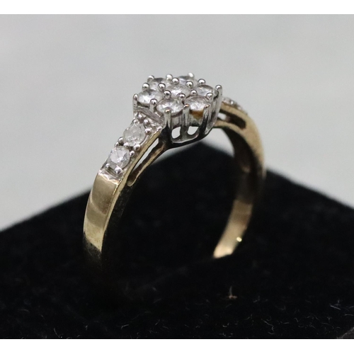 585 - A 9ct gold cluster ring set with small diamonds, Size N, 2.3 grams gross