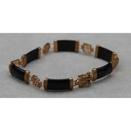 590 - An Oriental gilt metal and black panel bracelet