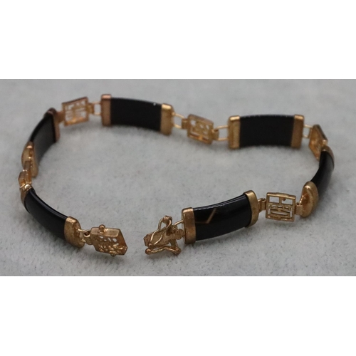 590 - An Oriental gilt metal and black panel bracelet