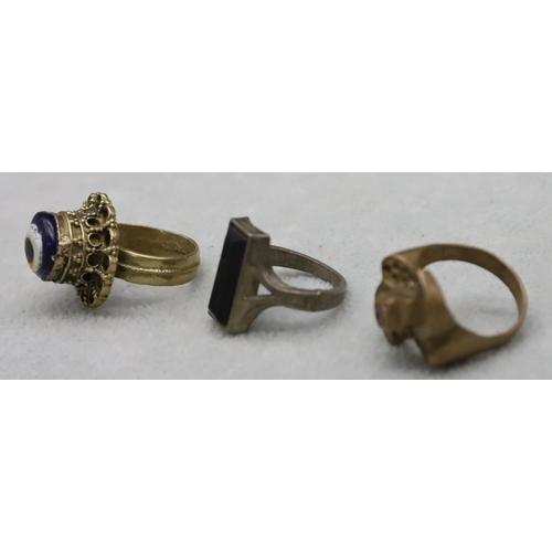 591 - A gilt metal ring, a similar gilt metal ring set with pink stone and another ring (3)