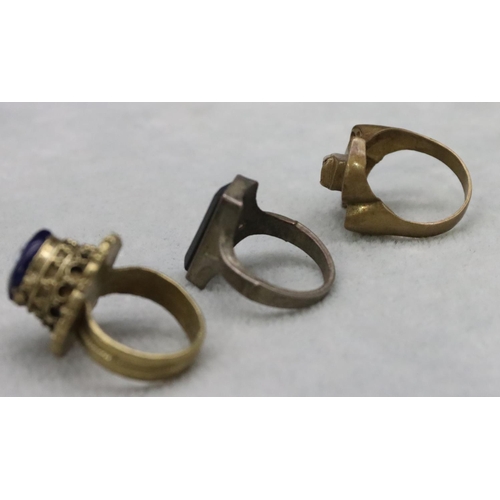 591 - A gilt metal ring, a similar gilt metal ring set with pink stone and another ring (3)