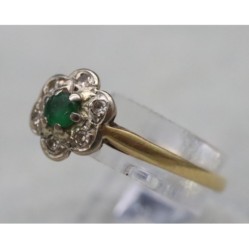 594 - A ladies' gold cluster ring set with centre emeralds surrounded by small diamond chips, Size M, 2 gr... 