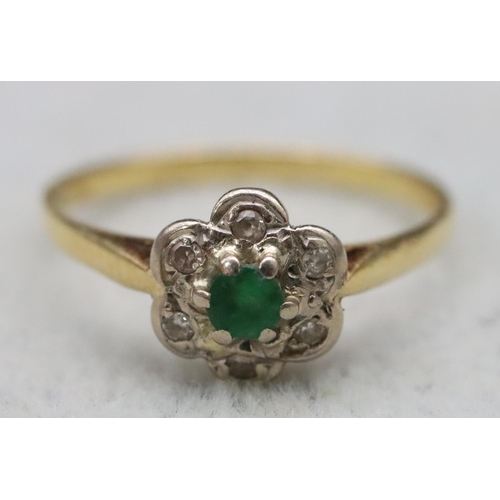 594 - A ladies' gold cluster ring set with centre emeralds surrounded by small diamond chips, Size M, 2 gr... 