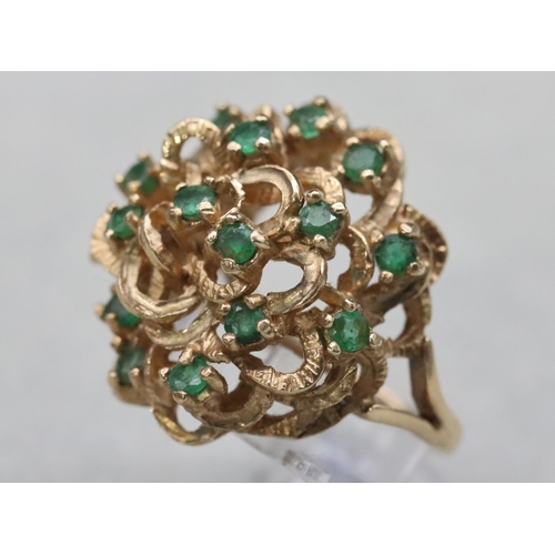 603 - A 9ct gold cluster ring set with various green stones, Size O/P, 8.8 grams gross