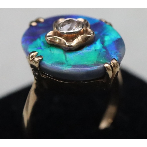 614 - An oval black opal ladies' ring set with centre diamond (Approx. 0.20ct), Size M/N, 3.9 grams gross