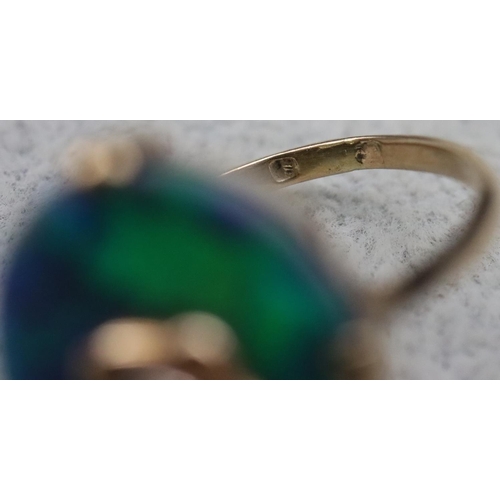 614 - An oval black opal ladies' ring set with centre diamond (Approx. 0.20ct), Size M/N, 3.9 grams gross