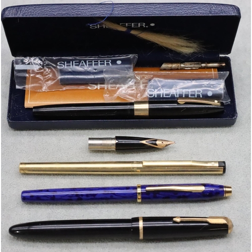 624 - A Parker Duofold black fountain pen, a Shaeffer fountain pen with extra nib (boxed), a Cross blue ma... 