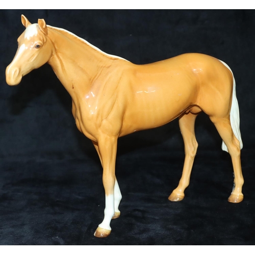 63 - A Beswick large figure of a Palomino horse, 28.5cm high, 25cm long (1 ear chipped)