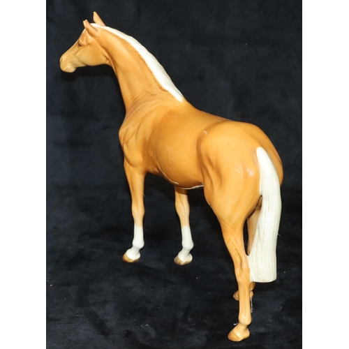 63 - A Beswick large figure of a Palomino horse, 28.5cm high, 25cm long (1 ear chipped)