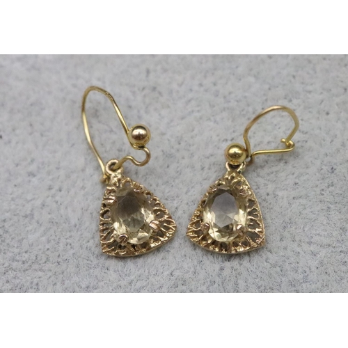 653 - A pair of 9ct gold drop earrings set with yellow coloured stones, 1.6 grams gross