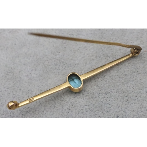 654 - A 9ct gold bar brooch mounted with centre topaz, 2.8 grams gross