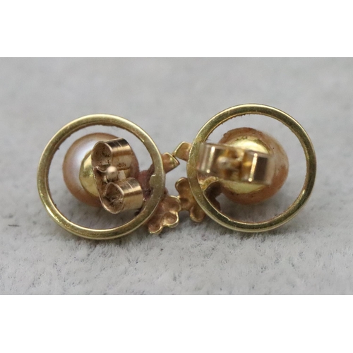 656 - A pair of 9ct gold earrings set with pearls, 3 grams gross