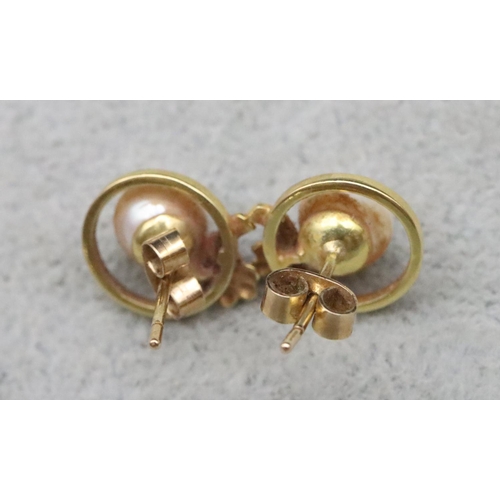 656 - A pair of 9ct gold earrings set with pearls, 3 grams gross