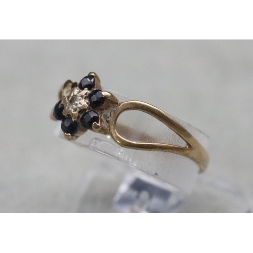 659 - A small 9ct gold ring set with centre diamond chips surrounded by small sapphires (1 sapphire missin... 