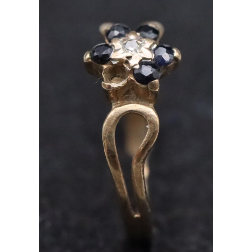 659 - A small 9ct gold ring set with centre diamond chips surrounded by small sapphires (1 sapphire missin... 