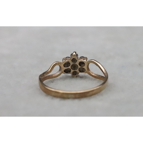 659 - A small 9ct gold ring set with centre diamond chips surrounded by small sapphires (1 sapphire missin... 