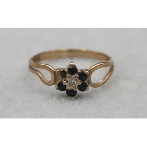 659 - A small 9ct gold ring set with centre diamond chips surrounded by small sapphires (1 sapphire missin... 