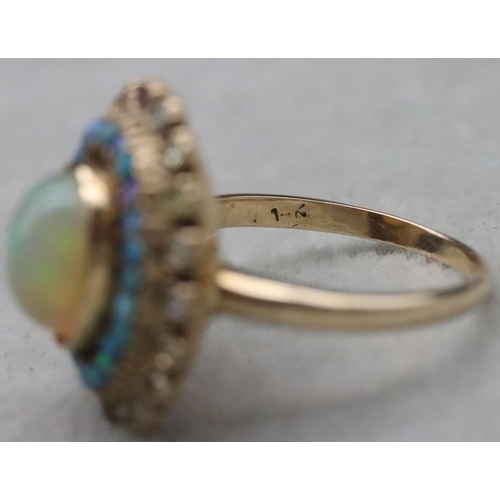 667 - A 14ct gold ladies' oval cluster ring set with centre opal surrounded by furthers opals with clear a... 