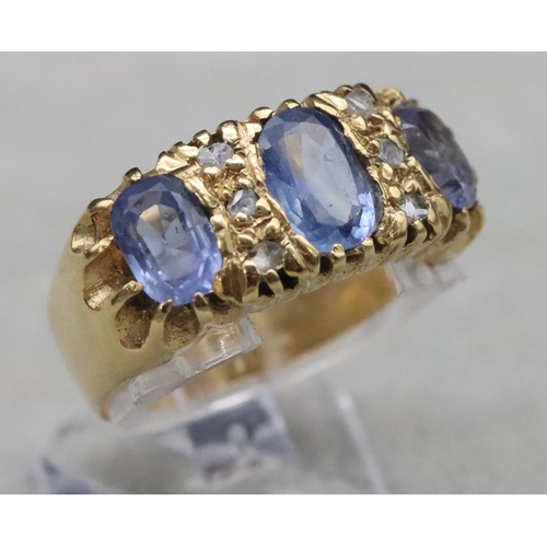 668 - An 18ct gold ring set with 3 pale sapphires interspersed with 6 small rough cut diamonds, Size S/T, ... 