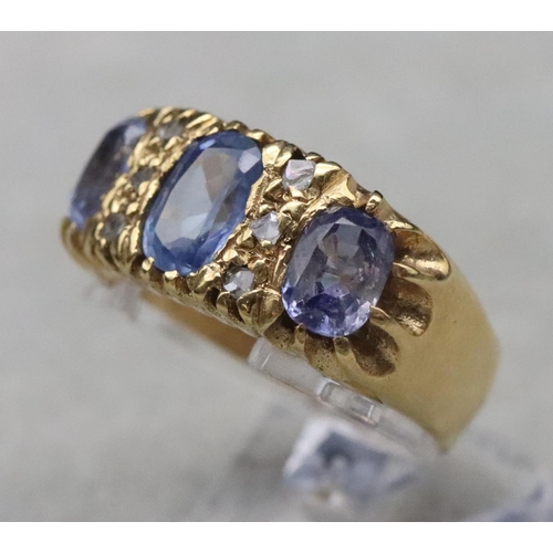 668 - An 18ct gold ring set with 3 pale sapphires interspersed with 6 small rough cut diamonds, Size S/T, ... 