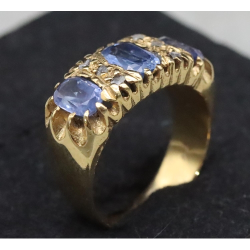 668 - An 18ct gold ring set with 3 pale sapphires interspersed with 6 small rough cut diamonds, Size S/T, ... 