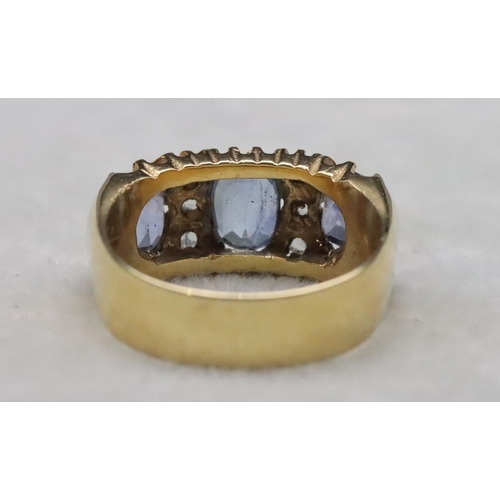 668 - An 18ct gold ring set with 3 pale sapphires interspersed with 6 small rough cut diamonds, Size S/T, ... 