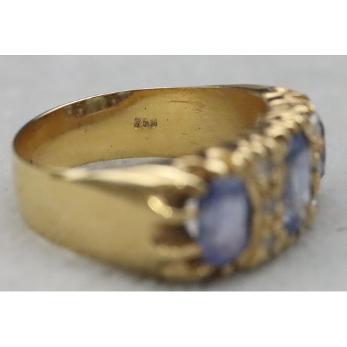 668 - An 18ct gold ring set with 3 pale sapphires interspersed with 6 small rough cut diamonds, Size S/T, ... 