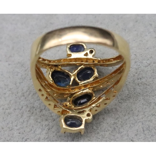 669 - An 18ct gold ladies' large cluster ring set with 5 sapphires interspersed with 3 rows of diamonds wi... 