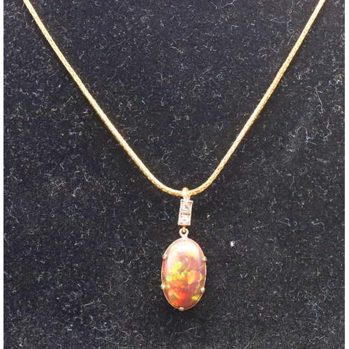 670 - A gold oval black opal drop pendant mounted with 2 small diamonds on high carat gold chain, 39.5cm l... 