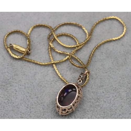 670 - A gold oval black opal drop pendant mounted with 2 small diamonds on high carat gold chain, 39.5cm l... 