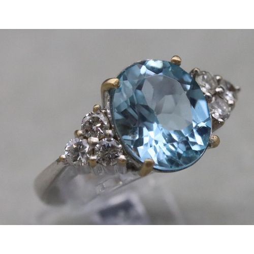 672 - An 18ct white gold ladies' ring set with large oval aquamarine, flanked by 6 diamonds, Size N/O, 10.... 