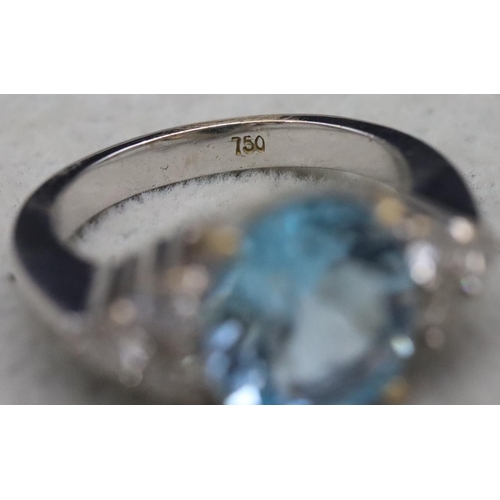 672 - An 18ct white gold ladies' ring set with large oval aquamarine, flanked by 6 diamonds, Size N/O, 10.... 