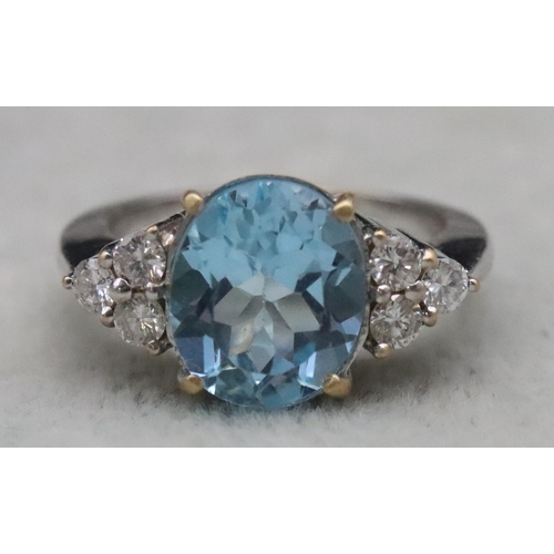 672 - An 18ct white gold ladies' ring set with large oval aquamarine, flanked by 6 diamonds, Size N/O, 10.... 