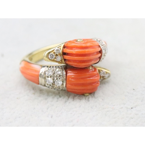 679 - An 18ct gold Italian coral twist ring in the form of 2 bird heads, each mounted with 9 diamonds to c... 