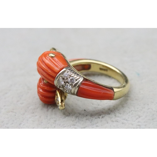 679 - An 18ct gold Italian coral twist ring in the form of 2 bird heads, each mounted with 9 diamonds to c... 