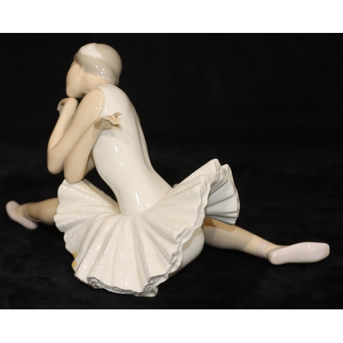 68 - A Lladro figure of a seated ballerina, 25cm long, 14cm high